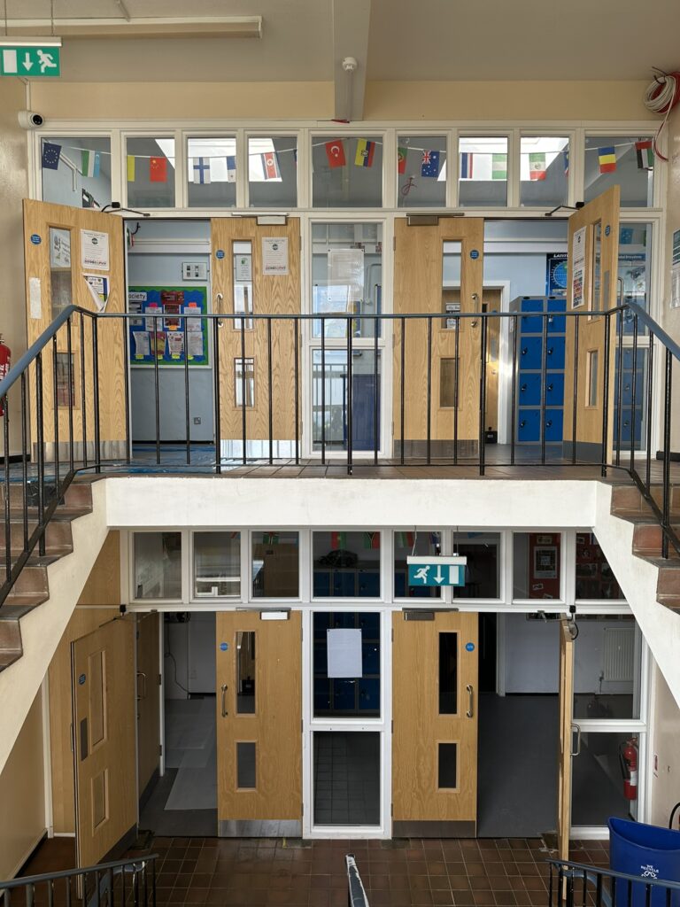 Fire Compliant Doors - Rainham Mark Grammar School - interior with upgraded fire doors and safety signage on multiple levels, enhancing building compliance and security.