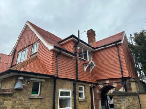 Completed CIF-funded school roof replacement with new red tiles and upgraded drainage system.