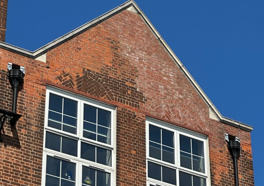 Condition survey image showing brickwork deterioration on a school building façade, highlighting the need for repair and maintenance.