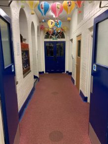 CIF-funded school refurbishment corridor with new flooring and doors.