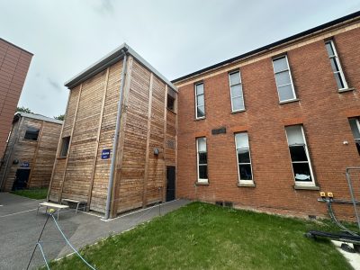 School exterior showing refurbished drama and music block with new cladding
