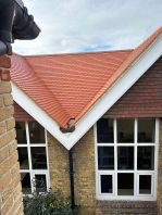 School roof valley with new red tiles installed during CIF-funded roof replacement project.