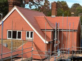 Newly tiled school roof completed under CIF-funded refurbishment project with scaffolding in place.