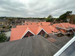 Aerial view of completed school roof replacement with new red tiles installed as part of CIF-funded refurbishment project.