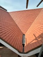 Completed school roof valley with new red tiles installed during CIF-funded replacement project.