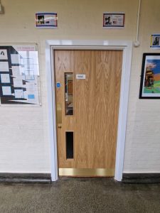 New classroom door installation in a school corridor as part of CIF-funded refurbishment project.
