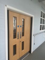 CIF-funded school fire safety improvements with new double fire door installation for compliance and protection.