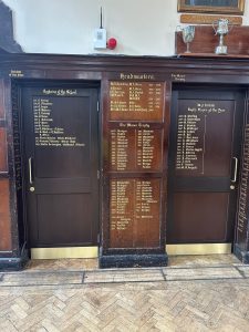 Wooden honours boards in a school hall listing headmasters, captains of the school and rugby players of the year, preserved during CIF-funded refurbishment.
