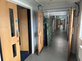 CIF-funded school fire safety upgrade with multiple new fire doors installed along corridor for compliance.