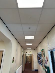 Upgraded school corridor with new suspended ceiling, energy-efficient LED lighting, and CIF-funded refurbishment improvements.