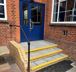 Blue door entrance with three steps and yellow safety edges.