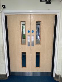 Newly installed CIF-funded fire doors in a school corridor, enhancing safety and compliance standards.