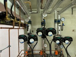CIF-funded school heating system upgrade showing new energy-efficient pumps, insulated pipework, and compliance installation.