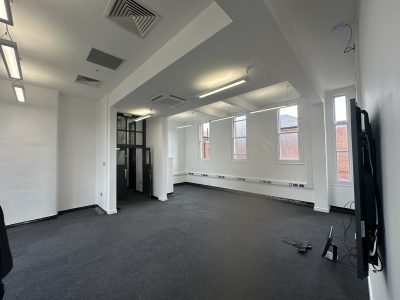 Refurbished modern classroom at Fort Pitt Grammar School featuring wall-mounted screen, new lighting and ventilation system.