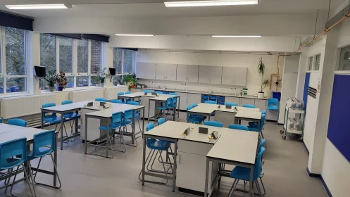 Heathside School - Case Study - Large science classroom with window-side workstations, central lab tables, and storage units.