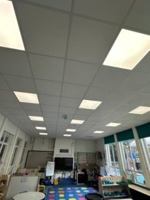 Refurbished classroom with new suspended ceiling and LED lighting installed to improve learning environment.