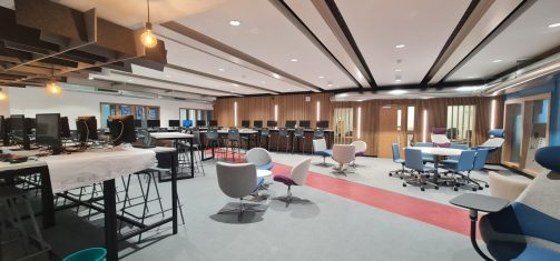 Open-plan study area with rows of computers, collaborative seating and flexible breakout zones.